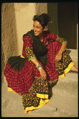Woman in fluffy skirt. The combination of dark brown, red and yellow colors