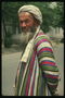 Asia. A man in a colorful, striped robe