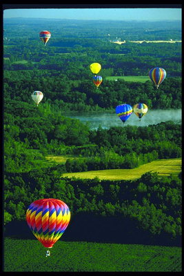 Balloon over the green forests and blue river