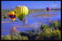 Multicolored balloons over the river