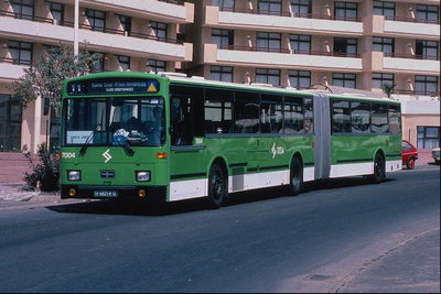 Running of the green bus in a residential area of the city