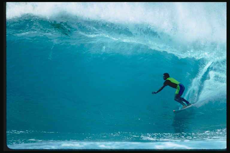 Серфингист наслаждается синим цветом воды и высокими волнами
