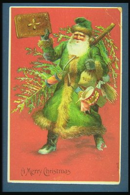 Santa i en grønn kjole med et tre og en bok i sine hender