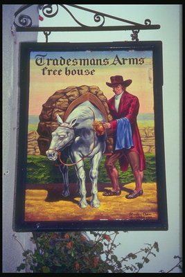 Вивіска із зображенням чоловіка та коні на тлі поля